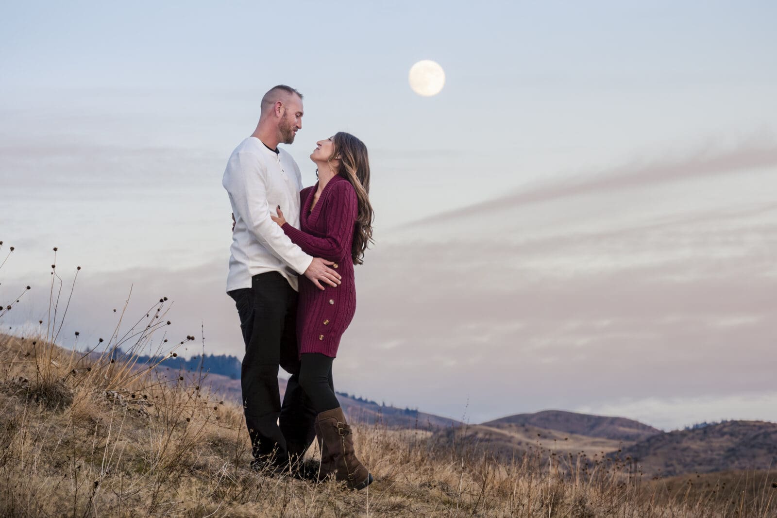 Couple posing under a full moon lunar love moon portrait session in the foothills of boise, Idaho