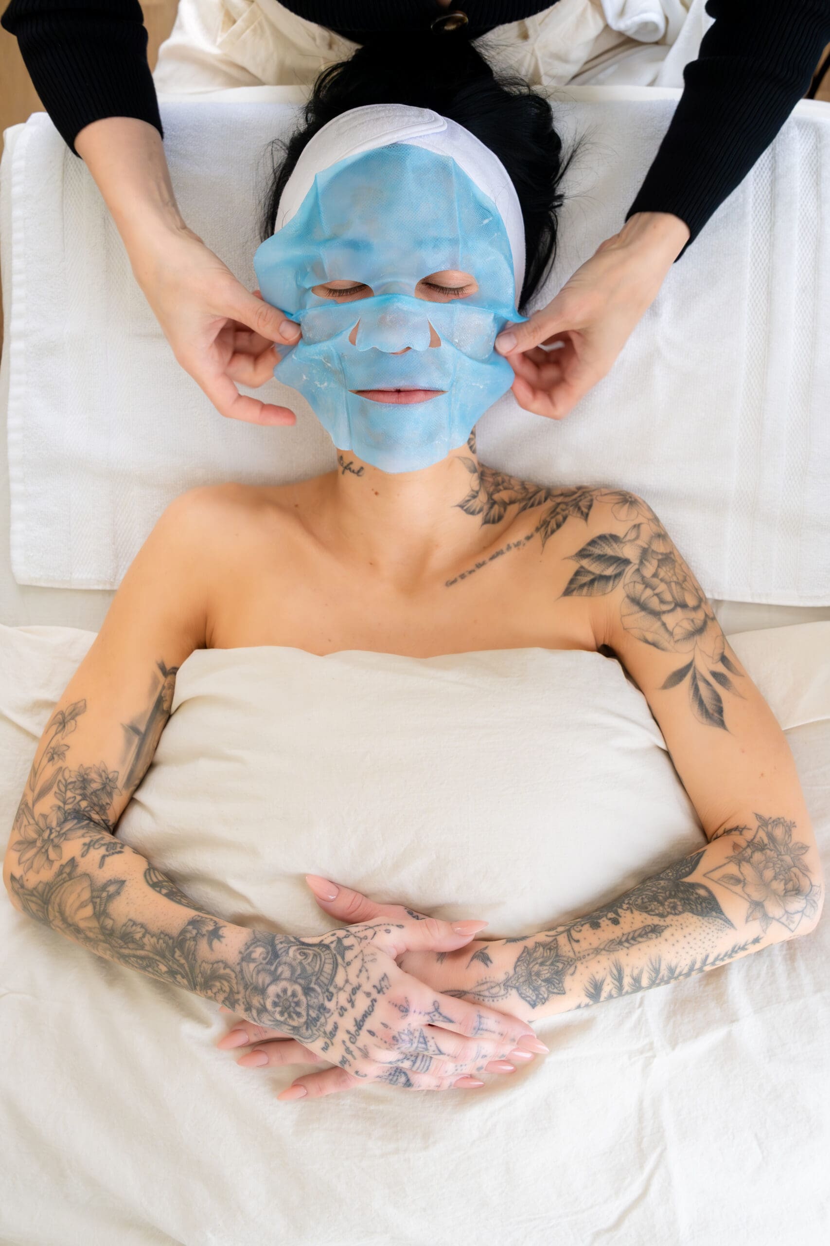 female gets aesthetic treatment mask put on after facial during Boise branding photographer photo shoot