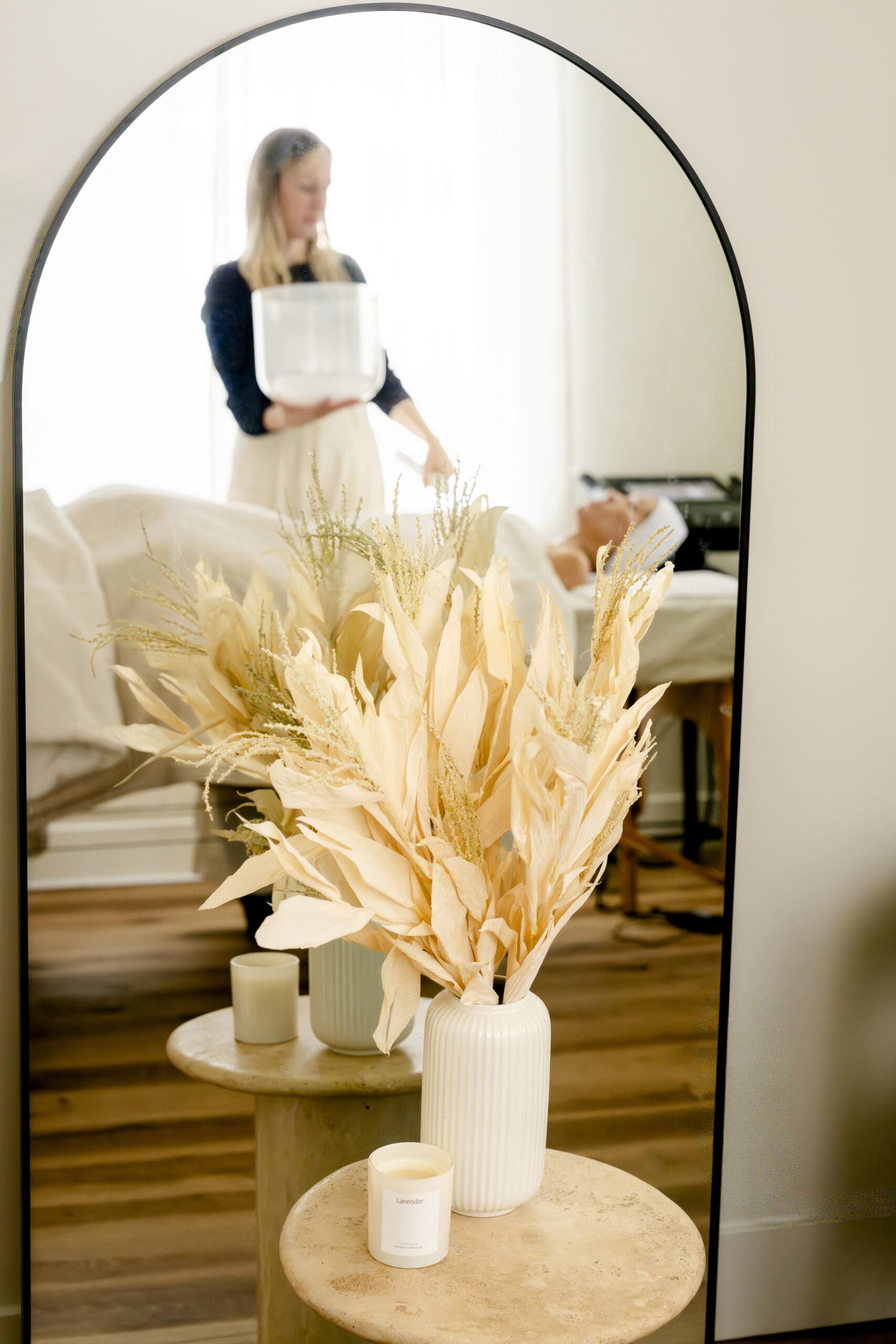 natural aesthetician providing sound therapy to client during treatment 