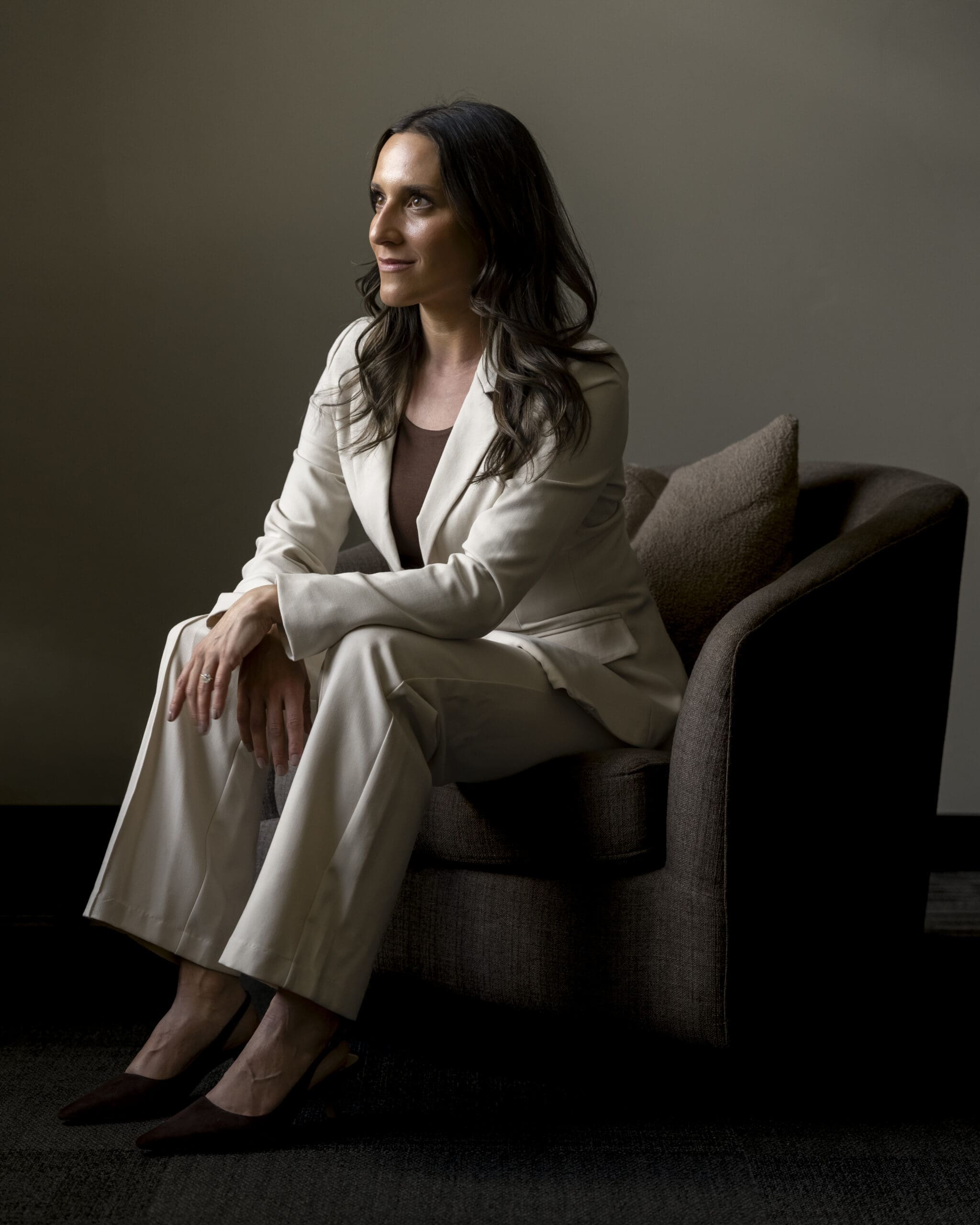 Editorial branding portrait of Boise medical aesthetics entrepreneur in modern neutral-toned office