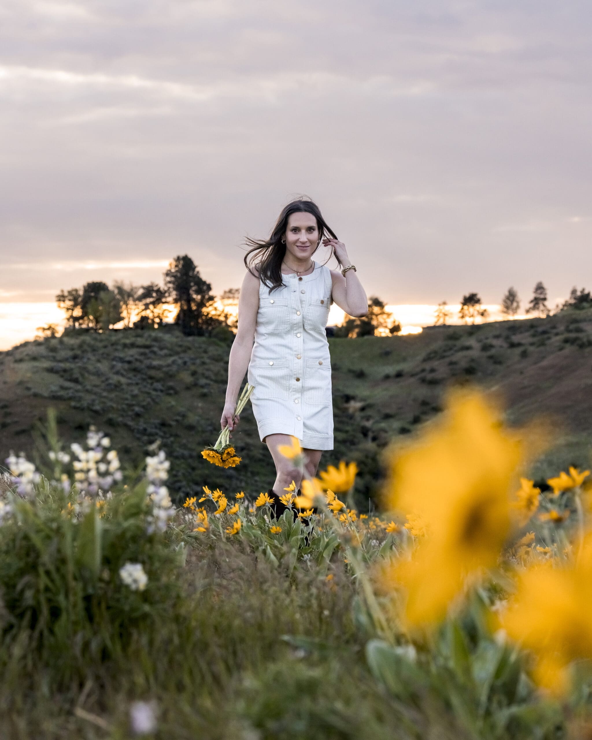 Outdoor branding portrait during golden hour in Boise foothills with wildflowers