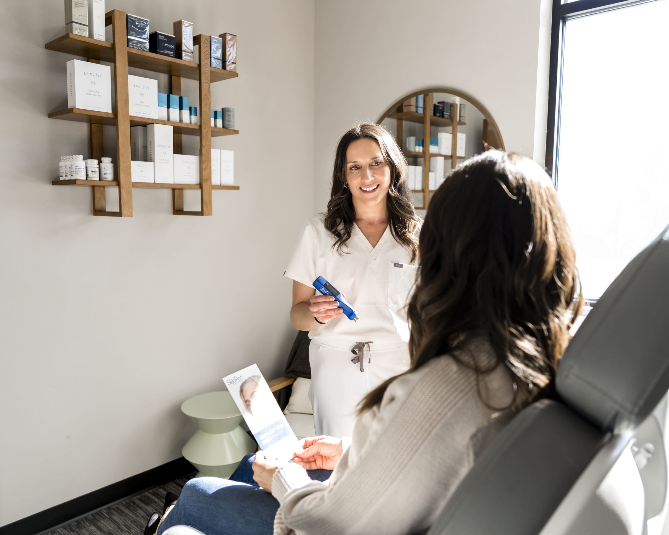Boise medical aesthetics provider discussing skincare treatment with client during branding photography session
