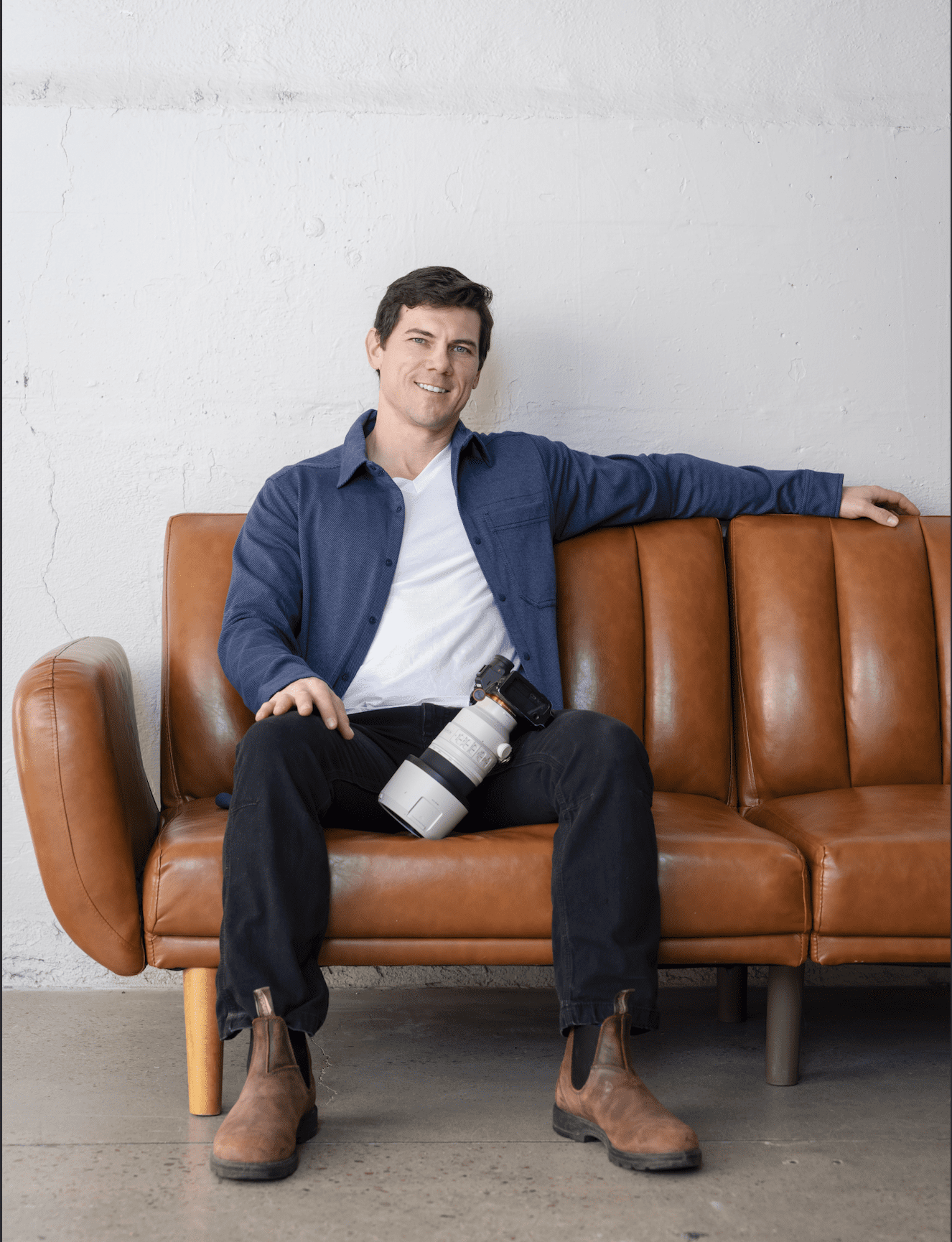 Boise branding photographer sitting on couch with camera