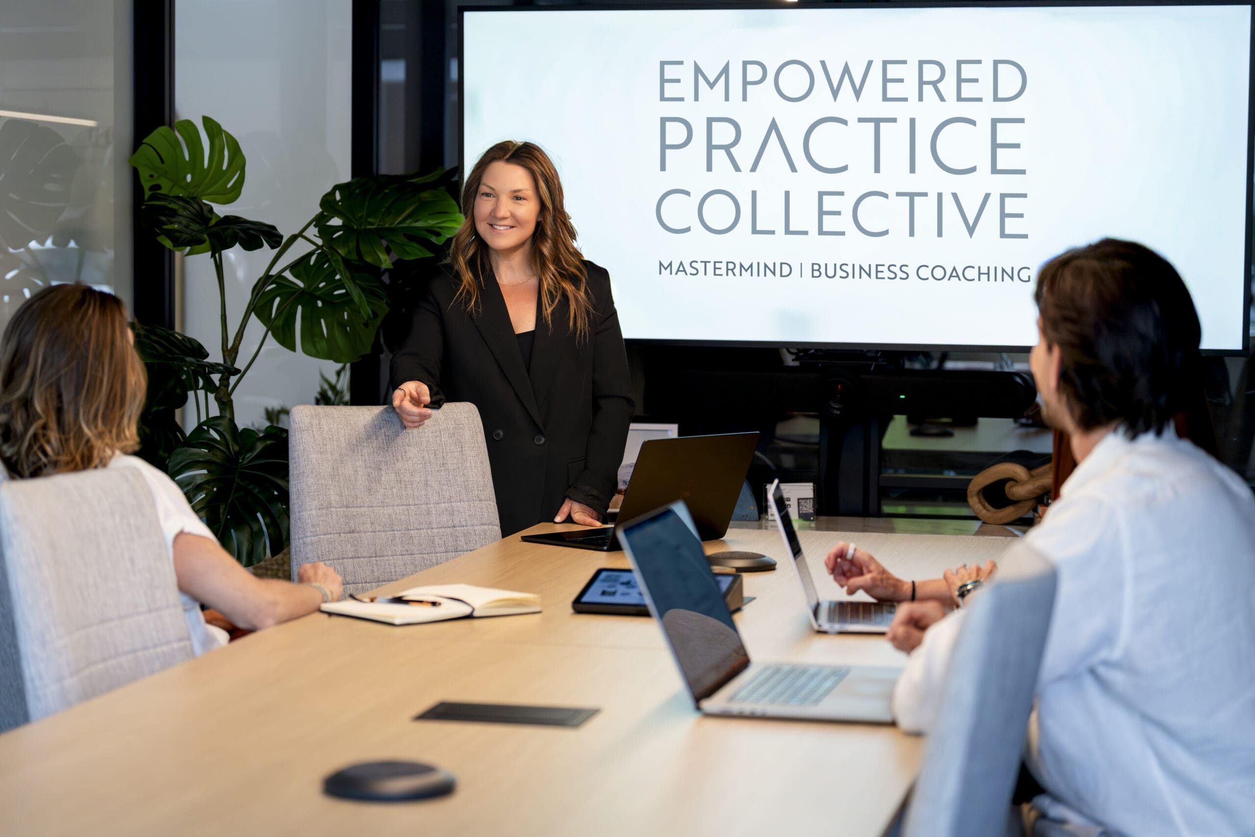 Functional medicine provider leading a business coaching session for healthcare practice owners during a branding photography shoot.
