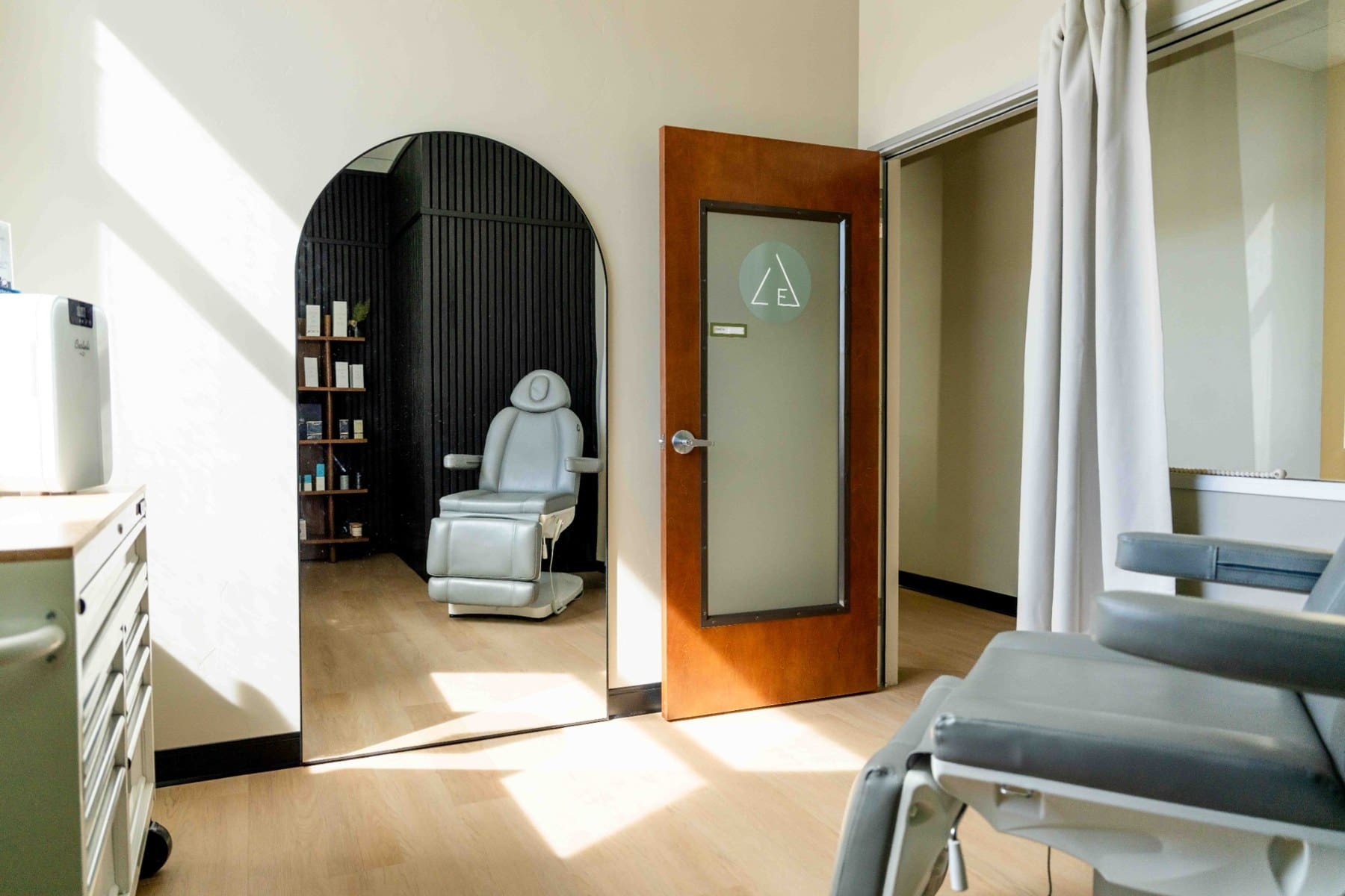 Open doorway connecting a seating area and treatment room