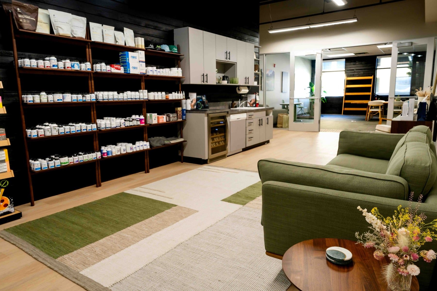 Product shelving beside the seating area inside the functional medicine office