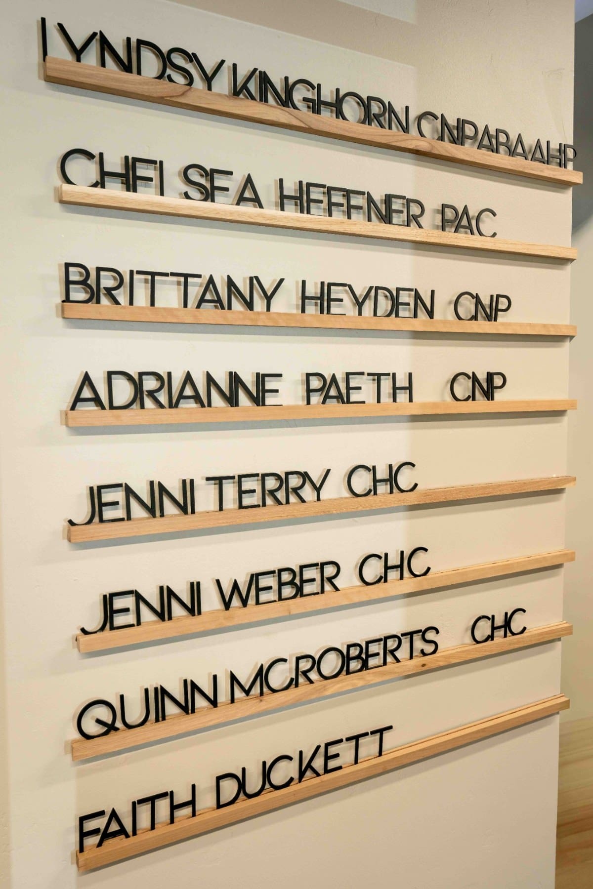 Individual practitioner names displayed on a wall-mounted directory